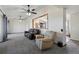 Inviting living room with carpeting and comfortable seating with a partial view of the kitchen at 44011 Morning Star Ct, Elizabeth, CO 80107