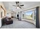Comfortable living room with large bay windows, wood floors, and a clear view of the outdoor space at 44011 Morning Star Ct, Elizabeth, CO 80107