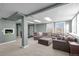 Spacious carpeted living room with a large sectional sofa, recessed lighting, and bright, airy windows at 44011 Morning Star Ct, Elizabeth, CO 80107