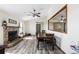 Living room view of a stone fireplace and decor with access to the dining room and laminate wood flooring at 44011 Morning Star Ct, Elizabeth, CO 80107