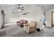 Spacious living room featuring neutral carpeting and two ceiling fans at 44011 Morning Star Ct, Elizabeth, CO 80107