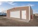 Metal shed, with a roll-up door, single entry door, and concrete pad at 44011 Morning Star Ct, Elizabeth, CO 80107