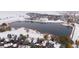 Aerial view of a snow-covered lake community surrounded by homes, trees and a walking path at 4009 Wonderland Hill Ave, Boulder, CO 80304