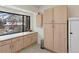 Spacious kitchen features light wood cabinets, ample countertop space, and a window with a view at 4009 Wonderland Hill Ave, Boulder, CO 80304
