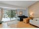 Cozy living room with wood-look flooring, natural light, and backyard views in winter at 4009 Wonderland Hill Ave, Boulder, CO 80304