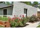 Quaint backyard features a flower garden, lush landscaping, and a detached garage or studio at 474 S Vine St, Denver, CO 80209