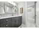 Elegant bathroom featuring gray vanity, marble countertop, and tiled shower at 474 S Vine St, Denver, CO 80209