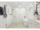 Modern bathroom with glass shower, soaking tub, and stylish gold fixtures at 474 S Vine St, Denver, CO 80209