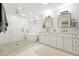 Luxurious bathroom featuring glass-enclosed shower, soaking tub, and dual vanity sinks at 474 S Vine St, Denver, CO 80209