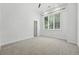 Bright bedroom with large window, neutral carpet, and fresh white paint at 474 S Vine St, Denver, CO 80209