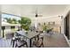 Relaxing covered deck features ample seating, dining table, ceiling fan, and a view of the backyard at 474 S Vine St, Denver, CO 80209