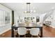 Bright dining room boasts an open layout, modern lighting, and hardwood floors connecting to the living area at 474 S Vine St, Denver, CO 80209
