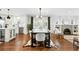 Bright dining area with hardwood floors, a modern chandelier, and views of the kitchen and living room at 474 S Vine St, Denver, CO 80209
