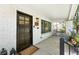Charming front porch featuring a dark wood door, black-framed windows, and stylish outdoor decor at 474 S Vine St, Denver, CO 80209