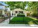 Charming home featuring a well-manicured lawn, black fencing, and an inviting front porch with garden accents at 474 S Vine St, Denver, CO 80209