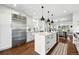 Bright kitchen features a large island, stainless steel appliances, and a seamless flow to the dining area at 474 S Vine St, Denver, CO 80209