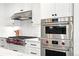 Modern stainless steel appliances including range top and oven with white subway tile backsplash at 474 S Vine St, Denver, CO 80209