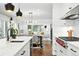 Open-concept kitchen with sleek countertops, modern appliances, and views to the dining area and living room at 474 S Vine St, Denver, CO 80209