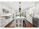 This gourmet kitchen boasts a spacious island, modern appliances, and a seamless connection to the outdoors at 474 S Vine St, Denver, CO 80209