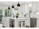 Kitchen island with modern fixtures, stainless steel appliances, seating, and views of the backyard at 474 S Vine St, Denver, CO 80209