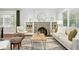Cozy living room with hardwood floors, a stone fireplace, and built-in bookshelves for stylish storage at 474 S Vine St, Denver, CO 80209