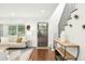 Bright living room with hardwood floors, a cozy couch, and natural light from the window at 474 S Vine St, Denver, CO 80209