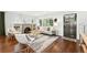 Inviting living room featuring hardwood floors, a stone fireplace, and comfortable seating at 474 S Vine St, Denver, CO 80209