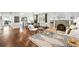 Open-concept living room with hardwood floors, a fireplace, and a dining area connected to the kitchen at 474 S Vine St, Denver, CO 80209