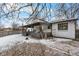 Exterior view of a white home with a covered patio and fenced backyard at 9565 W Lake Pl, Littleton, CO 80123
