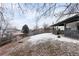 Large backyard with a wooden fence and covered patio, ideal for outdoor enjoyment at 9565 W Lake Pl, Littleton, CO 80123