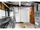 Utility area with a modern washer and dryer, water heater, and storage cabinet at 9565 W Lake Pl, Littleton, CO 80123