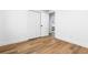 A clean and modern bedroom featuring light wood floors, a spacious closet, and ample natural light at 9565 W Lake Pl, Littleton, CO 80123