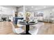 Elegant dining area with seating for four, leading into an open-concept living space at 9565 W Lake Pl, Littleton, CO 80123