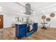 Well-appointed kitchen open to the dining area, boasting a sleek vent hood and modern design at 9565 W Lake Pl, Littleton, CO 80123