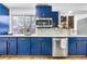 Modern kitchen design with blue cabinets, stainless steel appliances, and bright countertops at 9565 W Lake Pl, Littleton, CO 80123