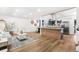 Bright living room seamlessly connects to a modern kitchen with stainless steel appliances and wood accents at 9565 W Lake Pl, Littleton, CO 80123