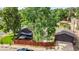 An aerial view showcasing the property's backyard with patio, detached garage and mature trees at 2990 S Sherman St, Englewood, CO 80113