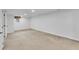 Spacious basement area with plush carpeting and bright, neutral walls at 2990 S Sherman St, Englewood, CO 80113