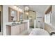Bright bathroom featuring a double sink vanity, glass shower, and a modern soaking tub at 2990 S Sherman St, Englewood, CO 80113