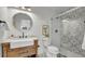 Stylish bathroom with rustic vanity, patterned tile, and glass-enclosed shower at 2990 S Sherman St, Englewood, CO 80113