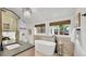 Bright bathroom featuring a soaking tub, modern vanity, and ample natural light, creating a spa-like experience at 2990 S Sherman St, Englewood, CO 80113
