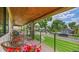 Inviting covered front porch with wicker furniture, decorative plants, and black metal railings at 2990 S Sherman St, Englewood, CO 80113
