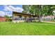 Charming single-story home featuring a welcoming front porch and lush green lawn at 2990 S Sherman St, Englewood, CO 80113