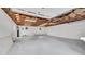 Unfinished two car garage with white walls, concrete flooring, and exposed wood rafters at 2990 S Sherman St, Englewood, CO 80113