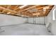Spacious, unfinished two car garage with exposed wood rafters and white walls at 2990 S Sherman St, Englewood, CO 80113