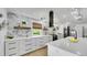 Gorgeous kitchen featuring an island, modern backsplash, stainless steel appliances, and hardwood floors at 2990 S Sherman St, Englewood, CO 80113