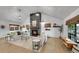 Open-concept living room with vaulted ceilings, fireplace, and large windows at 2990 S Sherman St, Englewood, CO 80113