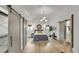 Spacious main bedroom with hardwood floors, stylish lighting, and sliding barn doors, creating a cozy retreat at 2990 S Sherman St, Englewood, CO 80113