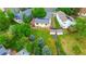 Aerial view of fenced backyard, mature trees, shed, and neighboring houses with solar panels at 7961 Jared Way, Littleton, CO 80125
