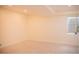 Bright and open basement with carpet flooring and a window for natural light at 7961 Jared Way, Littleton, CO 80125